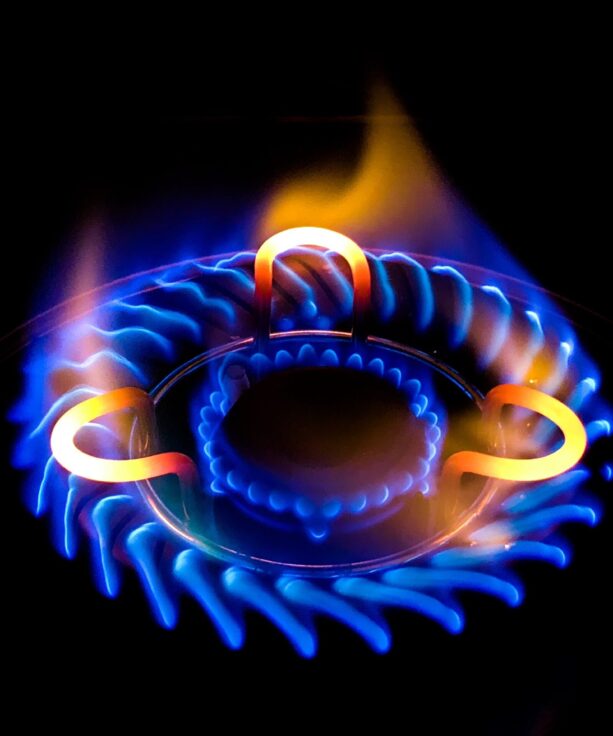 A closeup shot of a beautiful blue flame in a gas stove